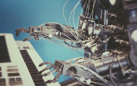 Robot playing a piano illustrating researchers from MIT developing a robot training method that uses AI techniques and a transformer model for improving robotics.