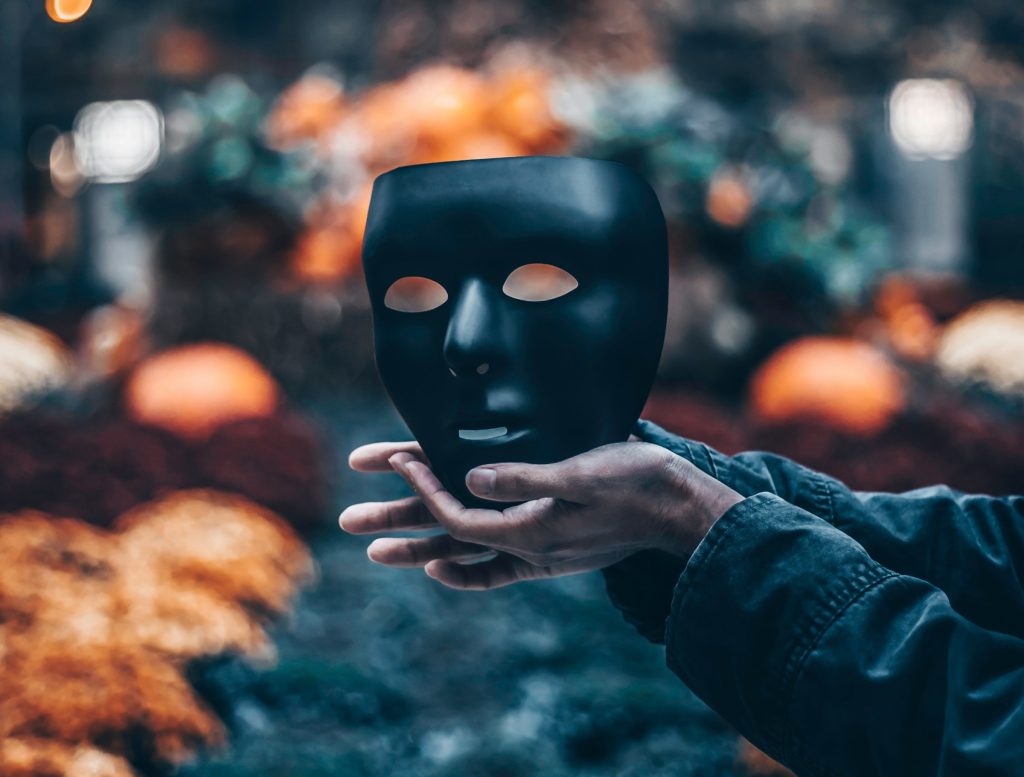 Person holding a mask following an AI sector study highlighting that record growth is masking serious challenges including skills, safety, infrastructure, security, and more, according to the authors of the report.