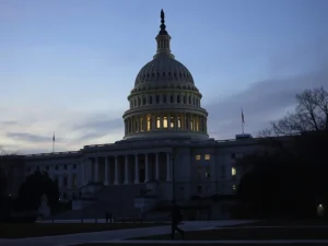U.S. government shutdown depicted by a dimly lit Capitol Building during a funding lapse.