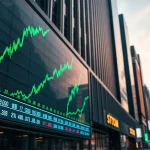Asian stock exchange display showing green market charts with city skyline at dusk