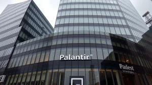Exterior view of Palantir Technologies headquarters building on a cloudy day.