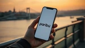 Person holding a smartphone showing Paribu and Polymarket integration with Istanbul skyline in background