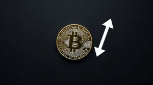 Bitcoin coin on dark surface with subtle downward arrow graphic, representing key price support level analysis.
