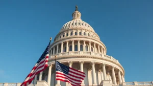 U.S. Capitol Building with American flag in foreground on a clear day