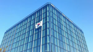 Exterior of the Korea Exchange (KRX) building in Busan, South Korea, on a clear day.